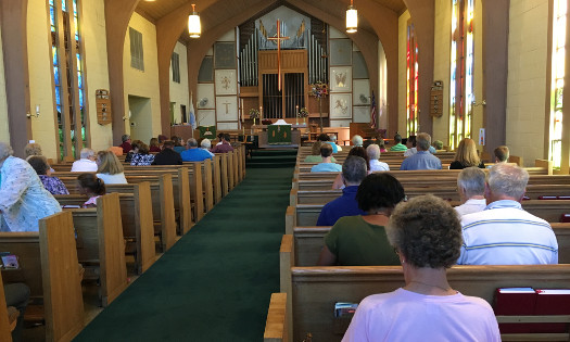 inside view of st. mark's sanctuary taken from the last row of pews looking forward